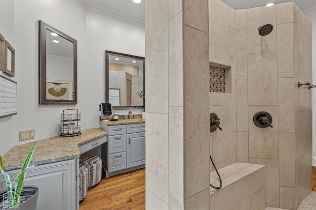 3500 Big Creek Cv, Jonesboro, AR 72404 - bathroom featuring a tile shower, ornamental molding, wood finished floors, vanity, and recessed lighting