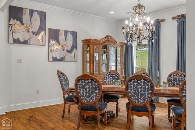 3500 Big Creek Cv, Jonesboro, AR 72404 - dining area with a chandelier, wood finished floors, crown molding, and recessed lighting