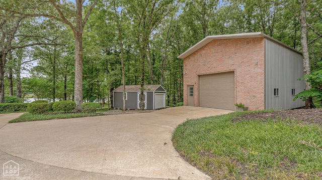 3500 Big Creek Cv, Jonesboro, AR 72404 - garage featuring concrete driveway and view of wooded area