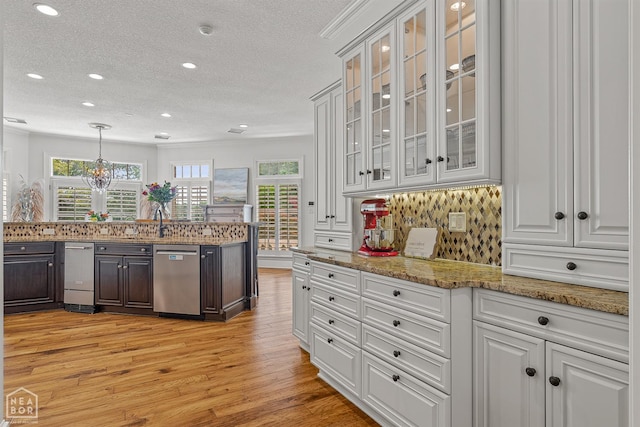3500 Big Creek Cv, Jonesboro, AR 72404 - kitchen featuring dishwasher, light wood-style flooring, decorative backsplash, healthy amount of natural light, and a textured ceiling
