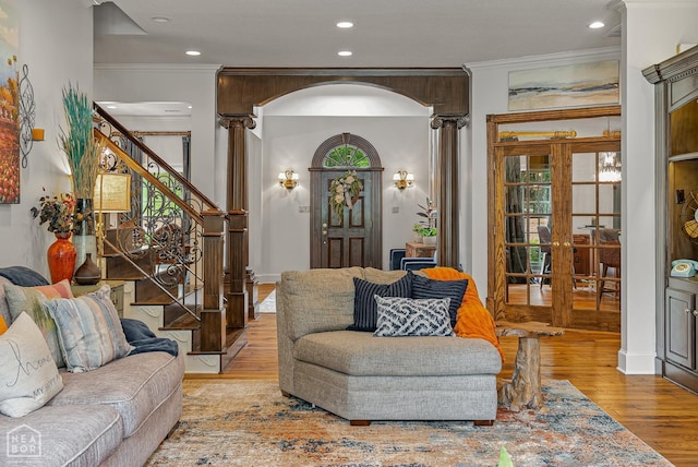 3500 Big Creek Cv, Jonesboro, AR 72404 - living area featuring wood finished floors, ornamental molding, stairs, arched walkways, and french doors
