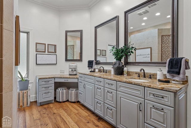 3500 Big Creek Cv, Jonesboro, AR 72404 - bathroom with double vanity, ornamental molding, wood finished floors, recessed lighting, and tiled shower