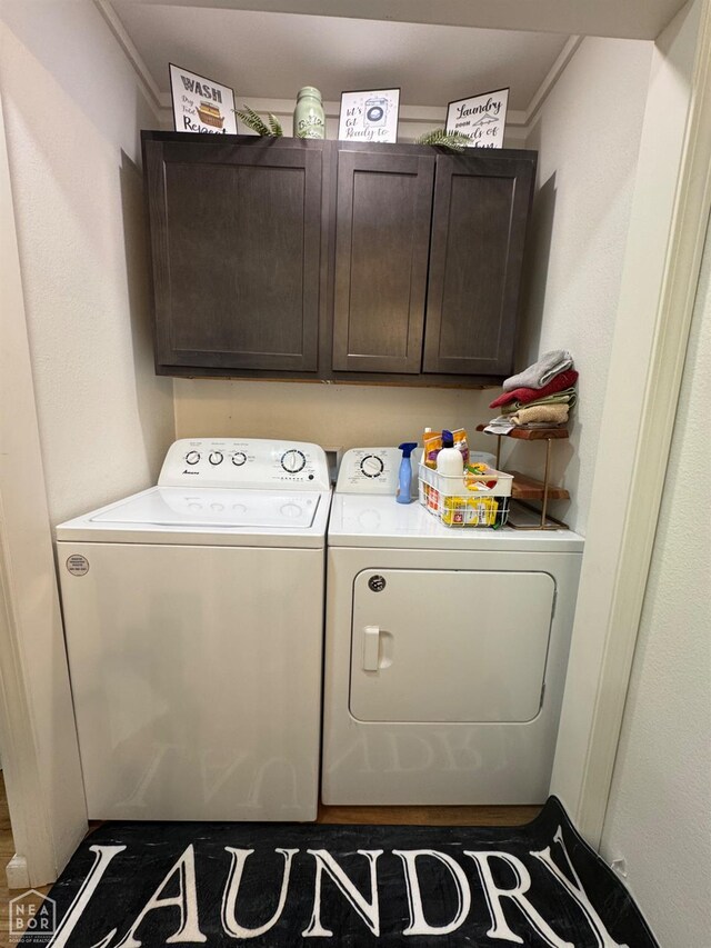 clothes washing area with independent washer and dryer, ornamental molding, and cabinet space