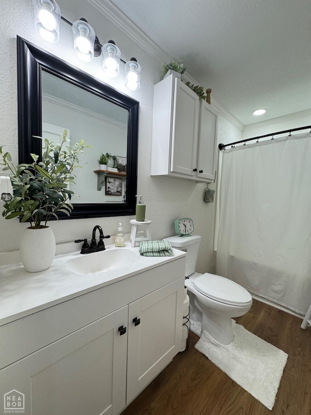 bathroom with toilet, wood finished floors, vanity, and shower / bath combination with curtain