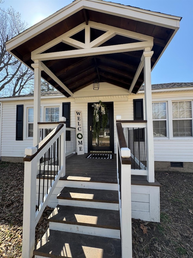 doorway to property with a porch and crawl space
