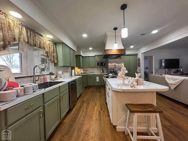 kitchen with green cabinets, light countertops, dark wood-type flooring, appliances with stainless steel finishes, and a sink