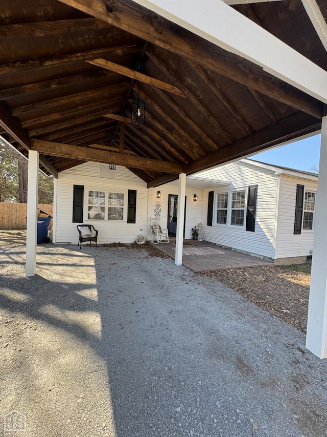 view of patio with fence and an attached carport