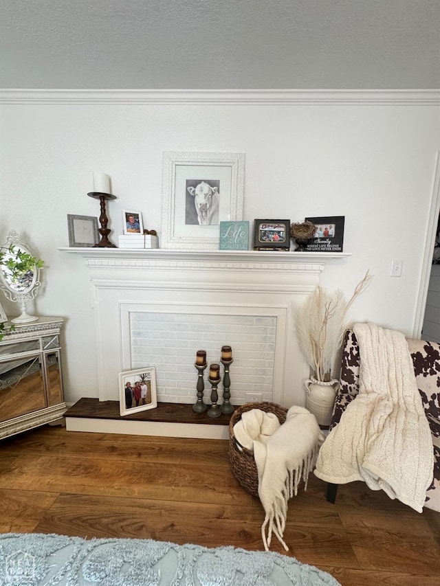 room details with ornamental molding, wood finished floors, and a textured ceiling