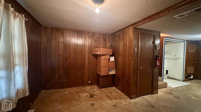 1703 W Oak Ave, Jonesboro, AR 72401 - hall featuring wooden walls and a textured ceiling