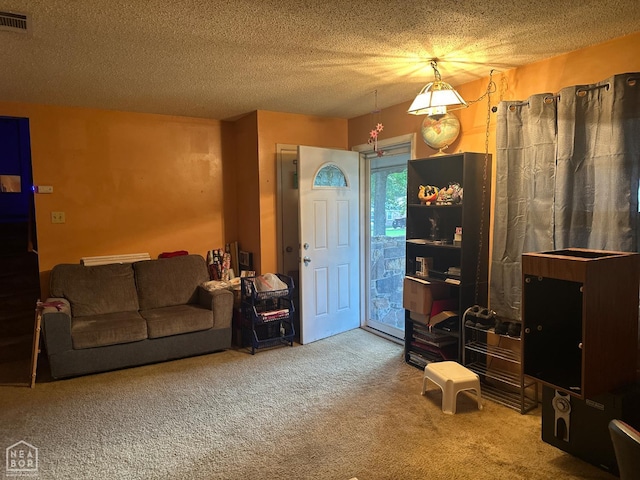 1703 W Oak Ave, Jonesboro, AR 72401 - living room with carpet and a textured ceiling
