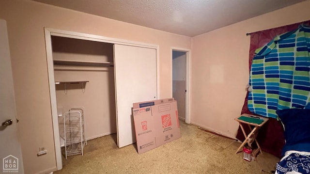 1703 W Oak Ave, Jonesboro, AR 72401 - carpeted bedroom with a closet and a textured ceiling