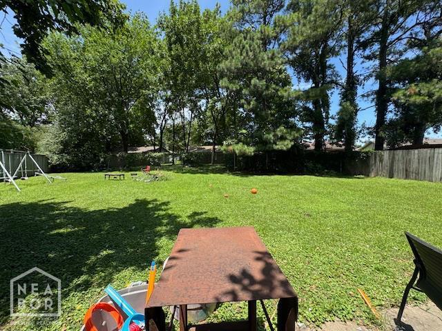 513 Meadowbrook St, Jonesboro, AR 72401 - fenced backyard featuring a playground
