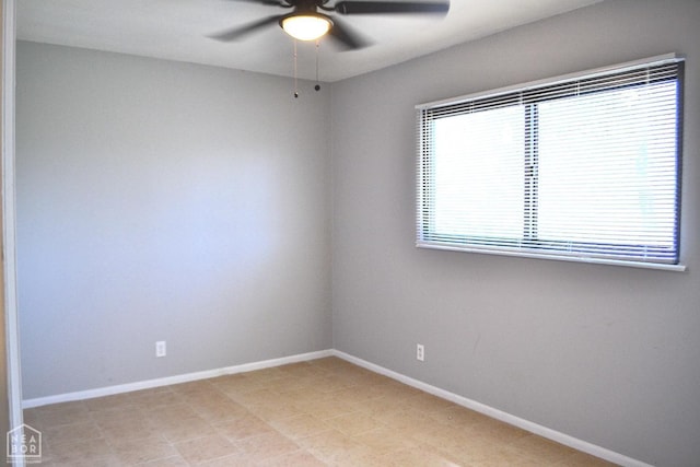 unfurnished room with baseboards and a ceiling fan