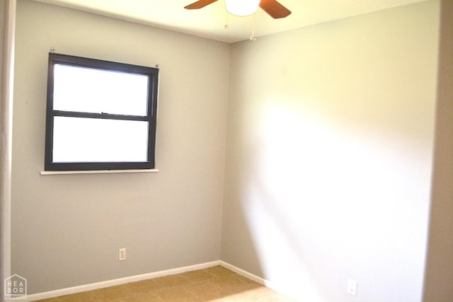 unfurnished room with baseboards and a ceiling fan