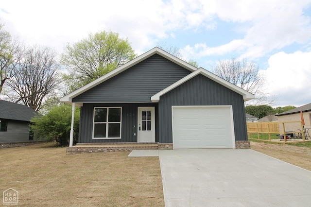 404 N 5th St, Paragould, AR 72450 - view of front of house with board and batten siding, concrete driveway, and an attached garage