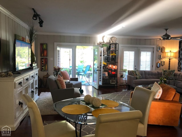living room featuring a ceiling fan, crown molding, and wood finished floors