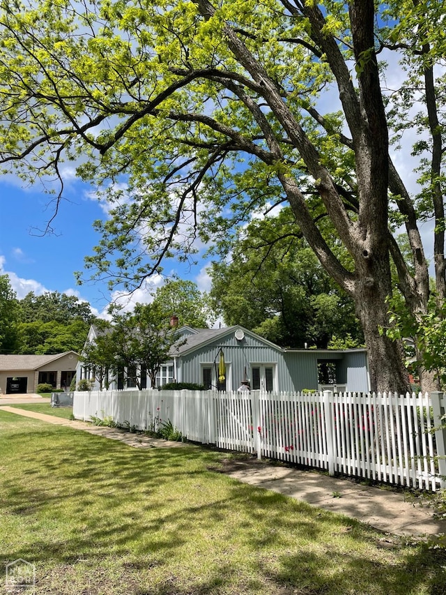 exterior space featuring a fenced front yard and a front lawn