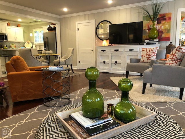 living room featuring ornamental molding, dark wood finished floors, and recessed lighting