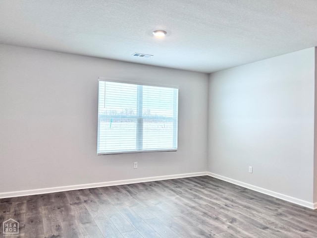 112 Terry Dr, Brookland, AR 72417 - empty room featuring wood finished floors, baseboards, and a textured ceiling