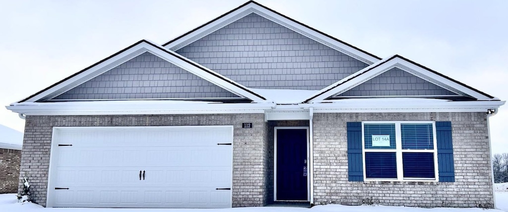 view of front of property with brick siding and an attached garage
