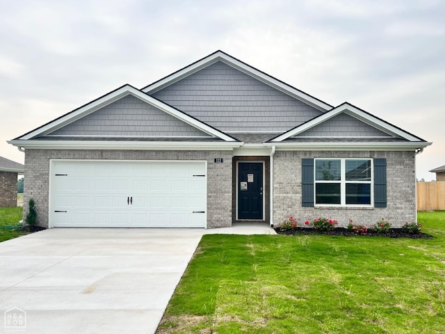 112 Terry Dr, Brookland, AR 72417 - view of front of house with driveway, an attached garage, and brick siding