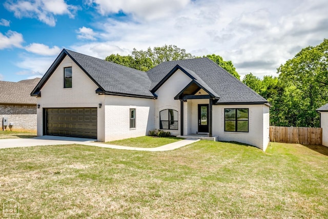 5040 Rockport Dr, Jonesboro, AR 72404 - view of front of home with a front lawn, fence, driveway, and an attached garage
