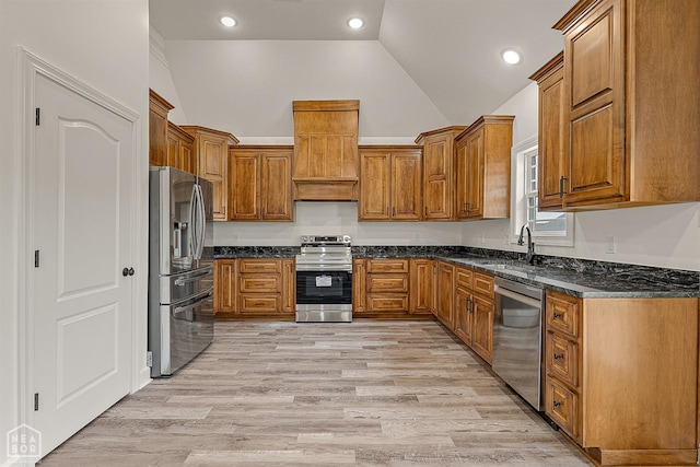 610 Airport Rd, Jonesboro, AR 72405 - kitchen with appliances with stainless steel finishes, lofted ceiling, brown cabinets, dark stone countertops, and a sink