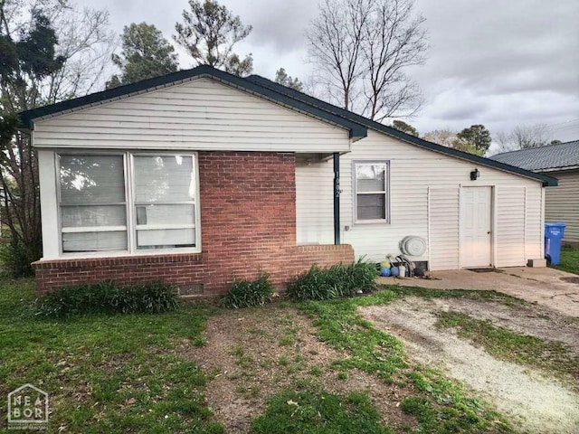 exterior space with brick siding and crawl space
