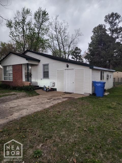 back of property with a yard