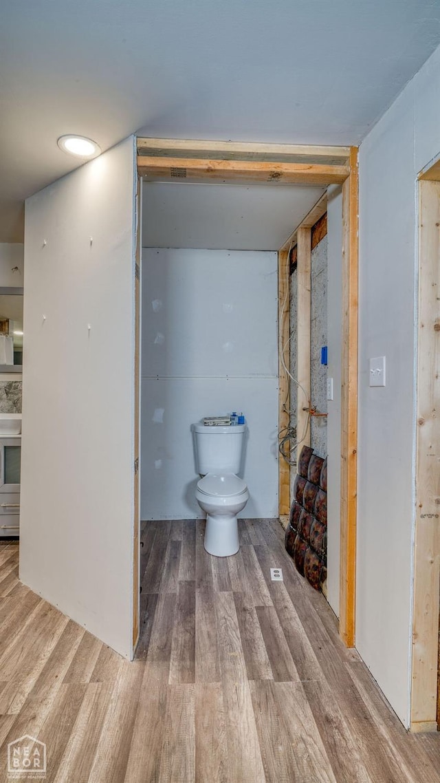 bathroom with toilet and wood finished floors