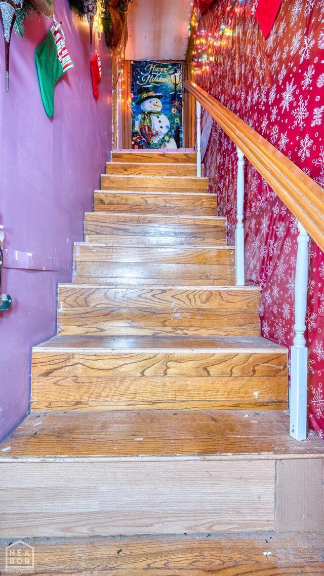 staircase with wallpapered walls