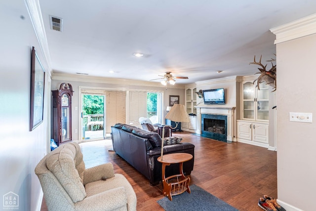 304 E Ridge Dr, West Helena, AR 72390 - living area featuring ornamental molding, a ceiling fan, a premium fireplace, wood finished floors, and baseboards