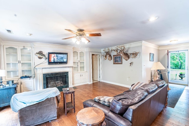 304 E Ridge Dr, West Helena, AR 72390 - living area with crown molding, wood finished floors, a ceiling fan, a premium fireplace, and baseboards