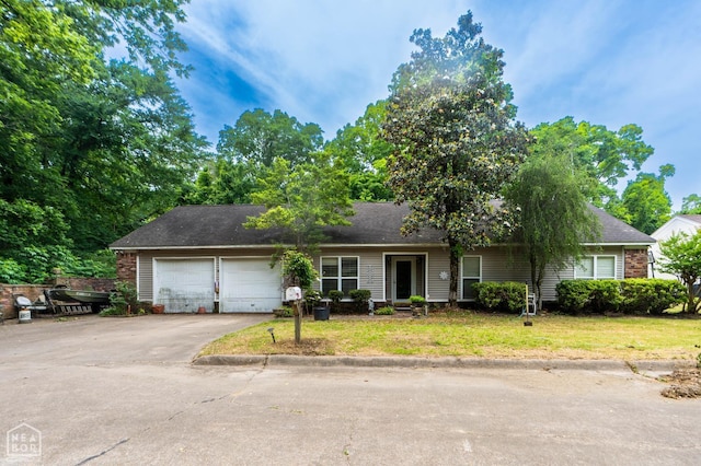 304 E Ridge Dr, West Helena, AR 72390 - ranch-style home with driveway, a garage, and a front yard
