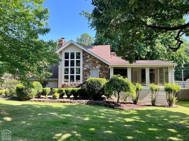 1804 Deerwood Dr, Jonesboro, AR 72404 - view of front of home featuring a front lawn, a chimney, and stone siding