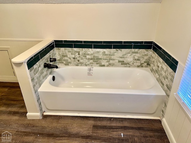 1804 Deerwood Dr, Jonesboro, AR 72404 - full bath featuring wood finished floors, a bath, and wainscoting