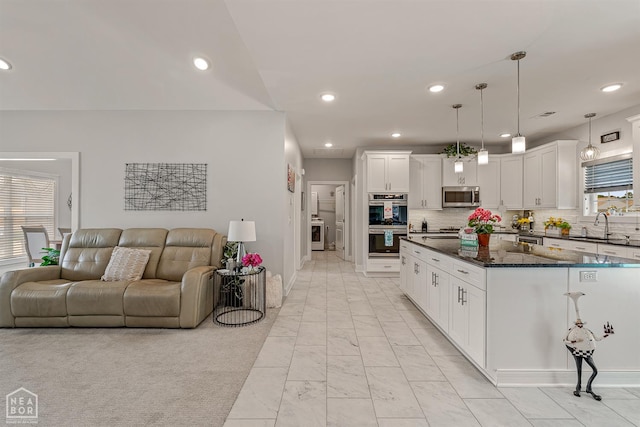 1502 S 30th St S, Paragould, AR 72450 - kitchen featuring appliances with stainless steel finishes, open floor plan, a sink, recessed lighting, and light marble finish floors