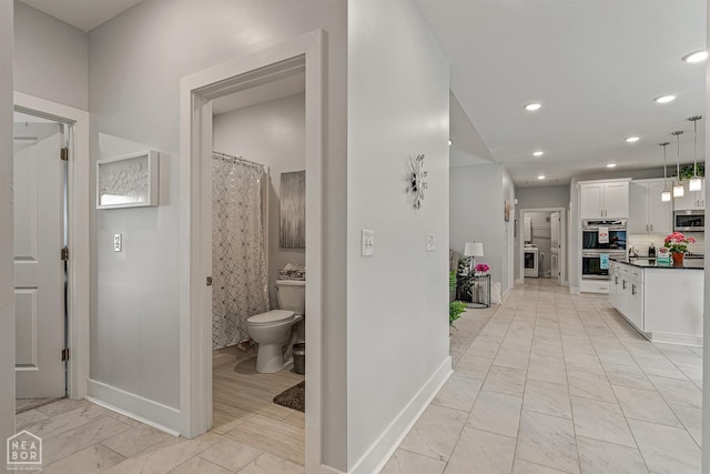 1502 S 30th St S, Paragould, AR 72450 - corridor featuring baseboards, light marble finish flooring, and recessed lighting