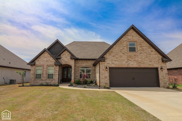 6509 Julia Ln, Jonesboro, AR 72404 - view of front of house with brick siding, a front lawn, driveway, an attached garage, and a shingled roof