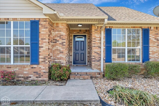 301 Natchez Dr, Jonesboro, AR 72404 - view of exterior entry featuring brick siding and roof with shingles