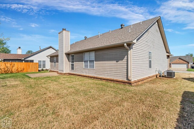301 Natchez Dr, Jonesboro, AR 72404 - rear view of property with central air condition unit, a yard, roof with shingles, fence, and a chimney