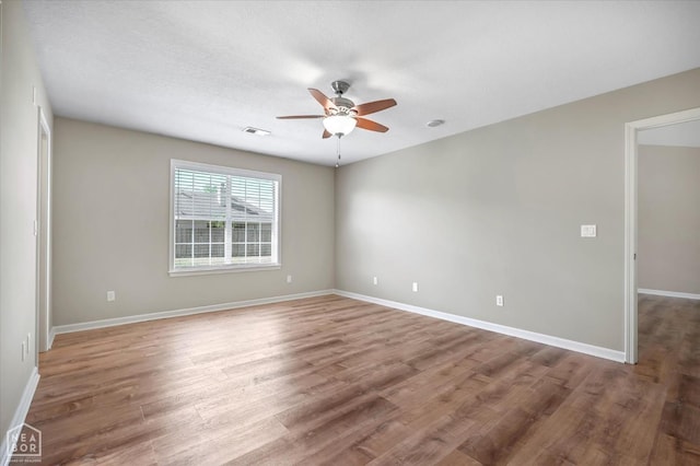301 Natchez Dr, Jonesboro, AR 72404 - unfurnished room with wood finished floors, ceiling fan, baseboards, and visible vents