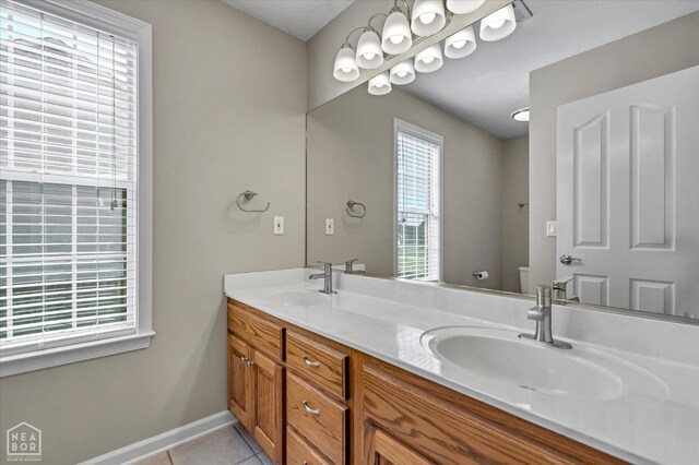 301 Natchez Dr, Jonesboro, AR 72404 - full bathroom with a sink, tile patterned floors, double vanity, and toilet