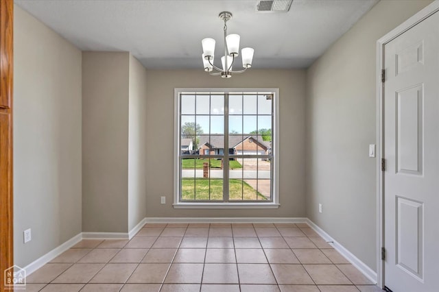 301 Natchez Dr, Jonesboro, AR 72404 - unfurnished room featuring visible vents, baseboards, a chandelier, and light tile patterned flooring