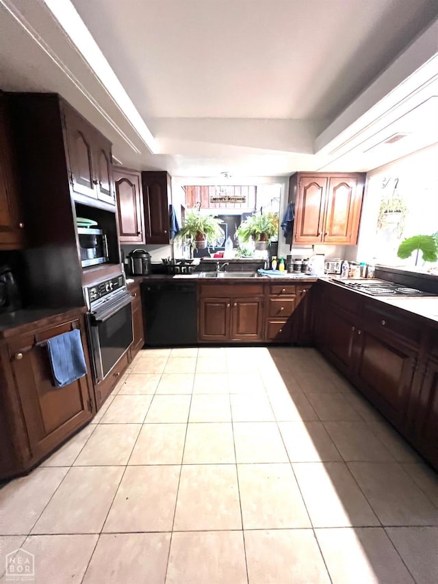 177 S Oak, Burdette, AR 72321 - kitchen featuring a sink, light tile patterned floors, a raised ceiling, and stainless steel appliances