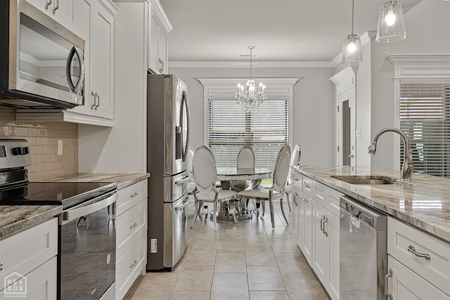 6605 Evan Cv, Jonesboro, AR 72404 - kitchen featuring appliances with stainless steel finishes, a sink, a chandelier, decorative backsplash, and white cabinetry