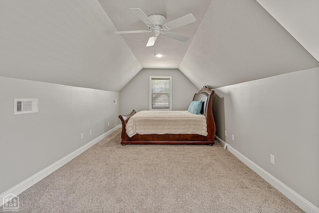 6605 Evan Cv, Jonesboro, AR 72404 - bedroom featuring carpet flooring, lofted ceiling, a textured ceiling, baseboards, and a ceiling fan