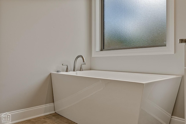 6605 Evan Cv, Jonesboro, AR 72404 - bathroom featuring a freestanding bath and baseboards