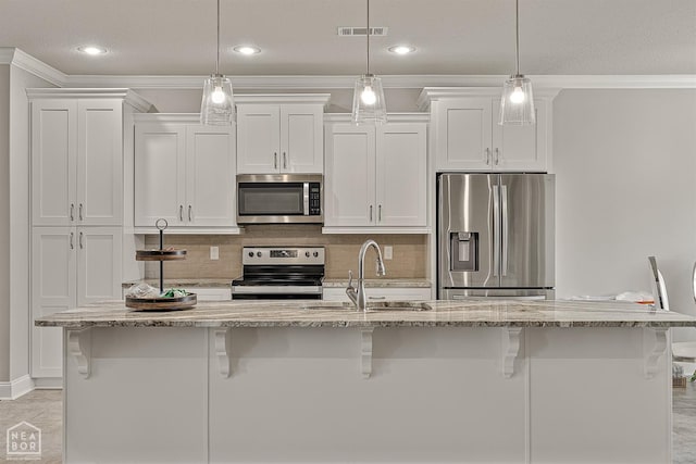 6605 Evan Cv, Jonesboro, AR 72404 - kitchen with appliances with stainless steel finishes, white cabinets, a kitchen breakfast bar, crown molding, and recessed lighting