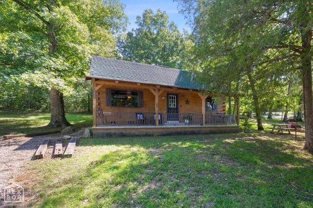 2 Star Falls Ln, Cherokee Village, AR 72529 - back of house featuring a porch, a shingled roof, and a lawn